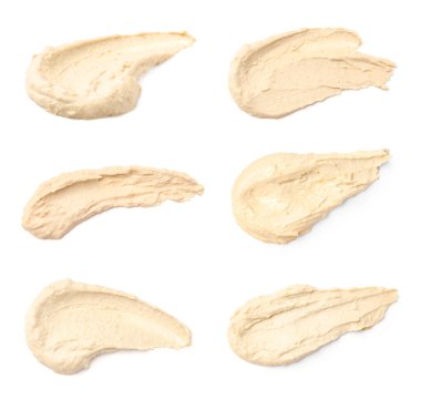 Set with smears of tasty hummus on white background