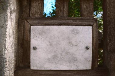 Wooden fence with blank metal sign outdoors. Space for text