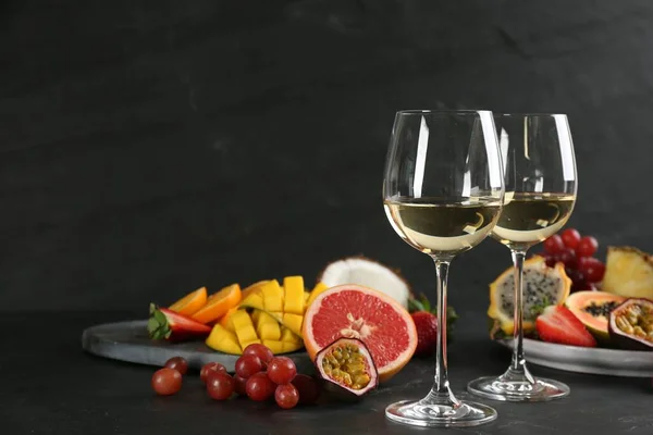 Delicious Exotic Fruits Glasses Wine Black Table Space Text — Stock Fotó