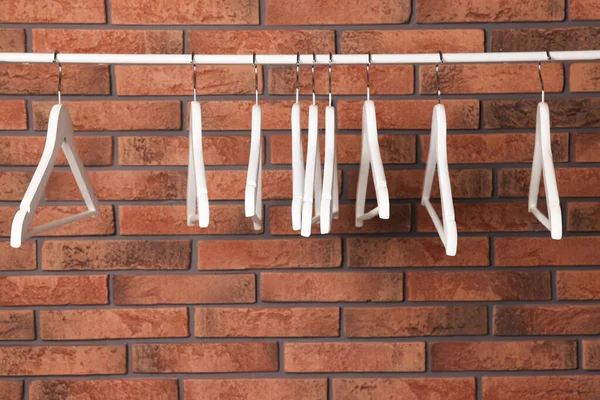 White Clothes Hangers Rail Red Brick Wall Space Text — 스톡 사진