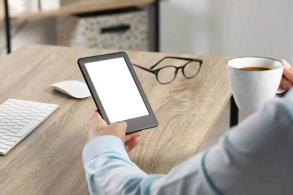 Man Cup Coffee Using Book Reader Wooden Table Indoors Closeup — Foto de Stock