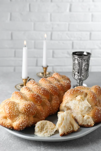Homemade Braided Bread Sesame Seeds Goblet Candles Grey Table Closeup — Fotografia de Stock