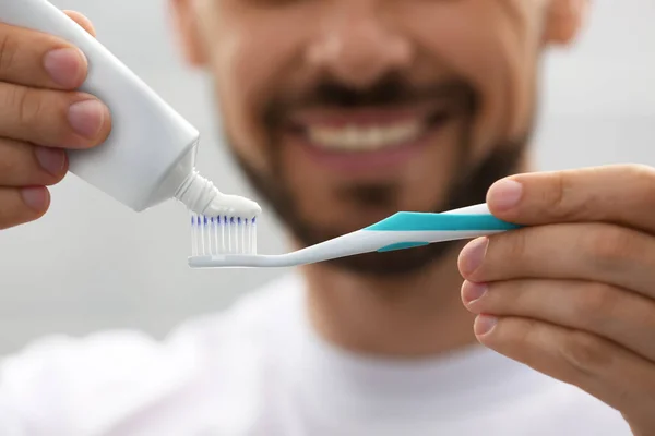 Man Applying Toothpaste Brush Blurred Background Closeup — Fotografia de Stock