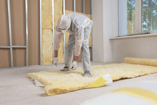 Worker Measuring Cutting Insulation Material Indoors — Stockfoto