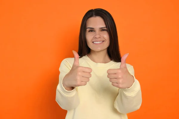 Young Woman Showing Thumbs Orange Background — Fotografia de Stock