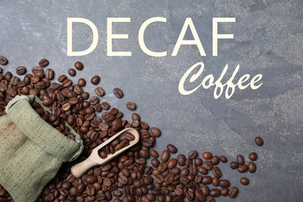 Decaf Coffee Beans Bag Wooden Scoop Grey Table Flat Lay — Stockfoto
