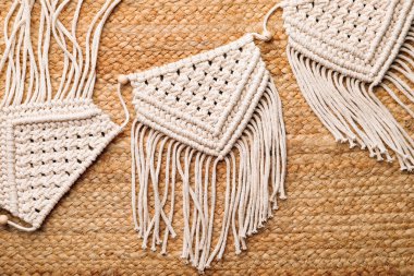 Large macrame on wicker straw background, flat lay