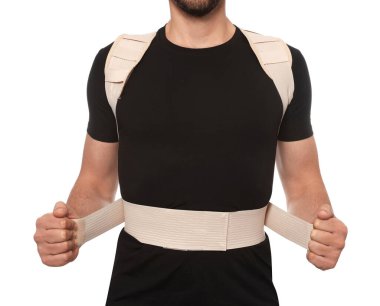 Closeup view of man with orthopedic corset on white background
