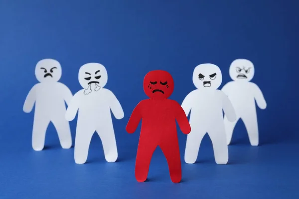 White Paper Figures One Red Blue Background Bullying Concept — Foto Stock