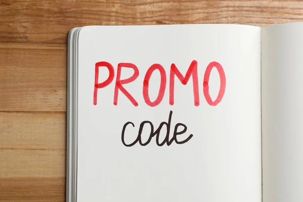 Notebook Words Promo Code Wooden Table Top View — Foto Stock