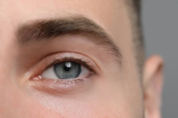 Closeup View Young Man Beautiful Eyes Grey Background — Stockfoto