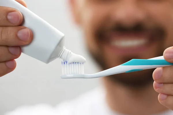 Man Applying Toothpaste Brush Blurred Background Closeup — Fotografia de Stock