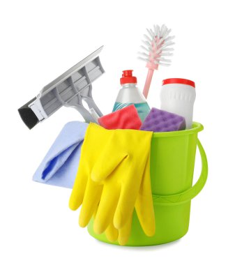 Green plastic bucket with different cleaning products isolated on white