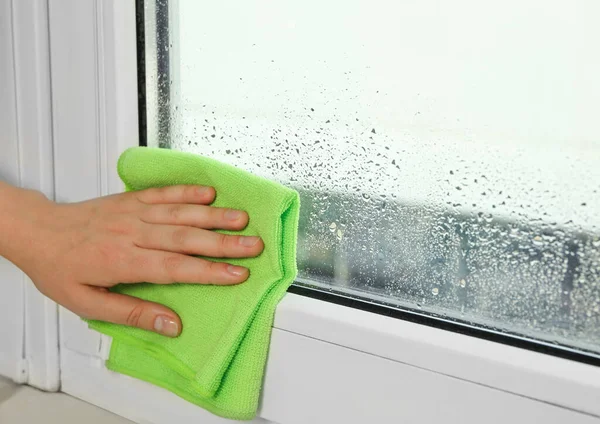 Woman Wiping Window Glass Drops Condensate Indoors Closeup Space Text —  Fotos de Stock