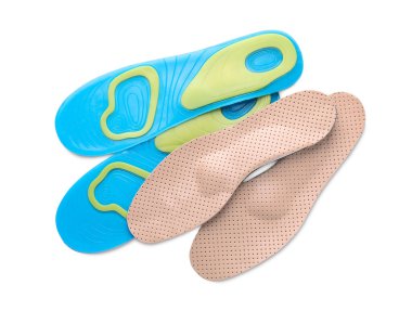 LIght blue and beige orthopedic insoles on white background, top view