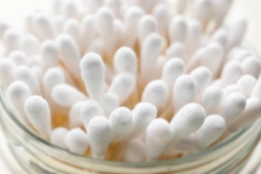 Many cotton buds in glass jar, closeup