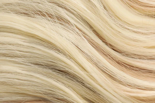 Beautiful blonde hair as background, closeup view