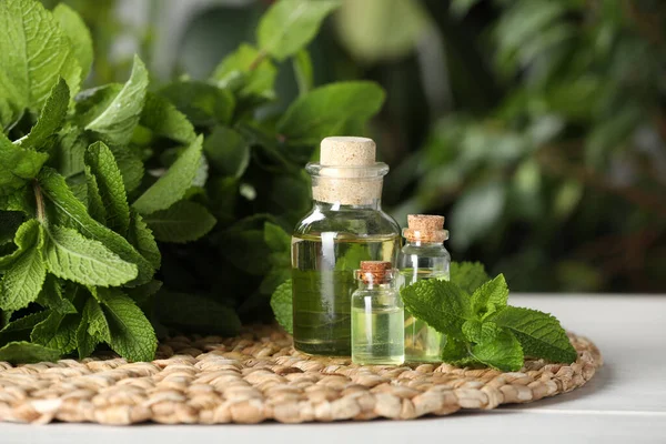 Bottles Mint Essential Oil Green Leaves White Wooden Table — Stockfoto