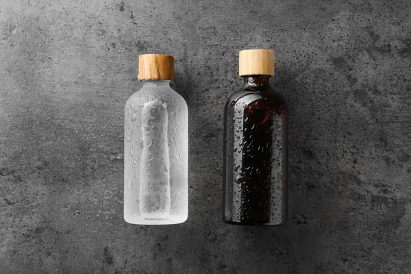 Bottles Cosmetic Product Wet Grey Background Flat Lay Space Text — Stock Photo, Image