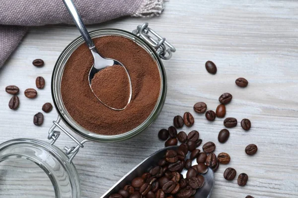 Flat lay composition with instant coffee on white wooden table