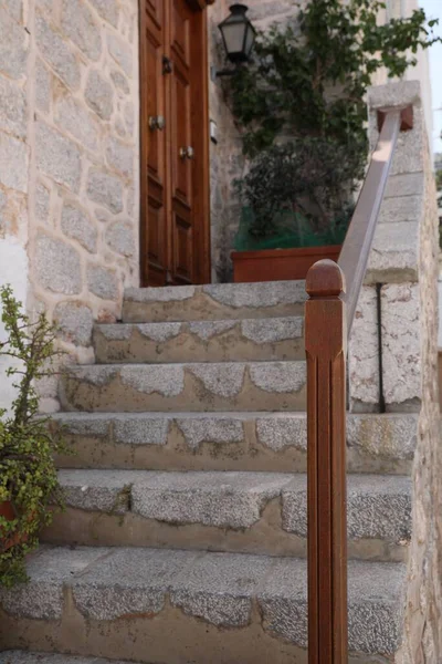 Beautiful stone stairs with wooden railing near building
