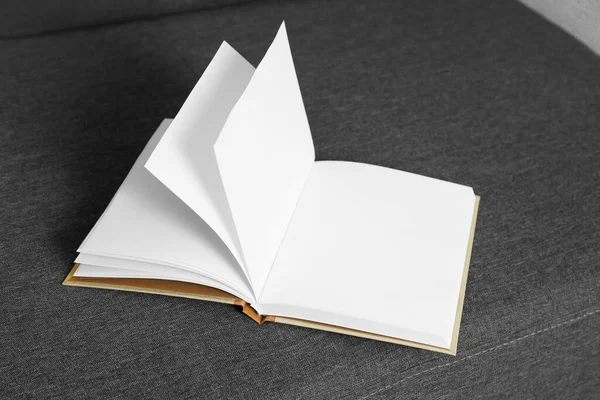 Open Blank Hardcover Book Grey Sofa —  Fotos de Stock