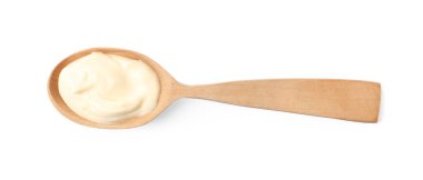 Mayonnaise in wooden spoon isolated on white, top view