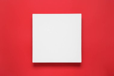 Blank canvas on red background, top view. Space for design