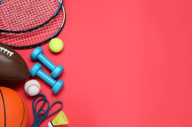 Set of different sports equipment on red background, flat lay. Space for text