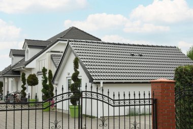 Modern buildings with grey roofs in forest on spring day