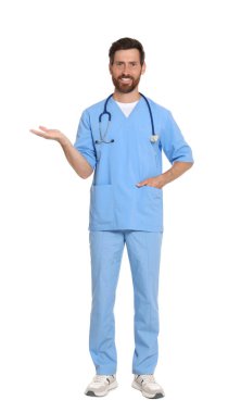 Full length portrait of doctor in scrubs on white background