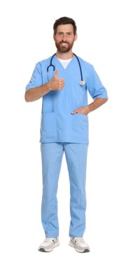 Full length portrait of doctor in scrubs on white background