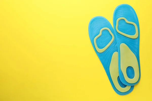 Light Blue Orthopedic Insoles Yellow Background Flat Lay Space Text — Stok fotoğraf