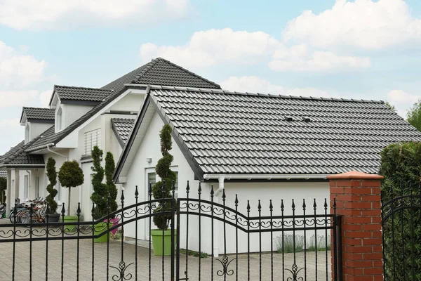 Modern buildings with grey roofs in forest on spring day