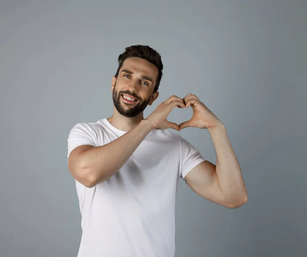 Happy Man Making Heart Hands Grey Background — Foto de Stock