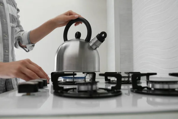 Woman Putting Kettle Gas Stove Kitchen Closeup — стоковое фото