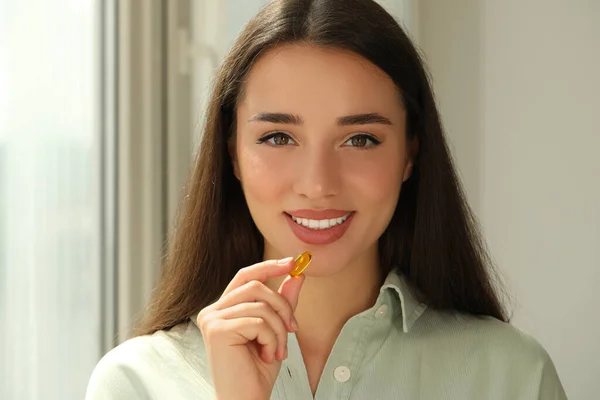 Young Woman Taking Dietary Supplement Pill Indoors — 스톡 사진