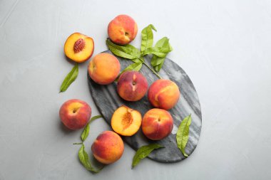 Fresh sweet peaches on light table, flat lay