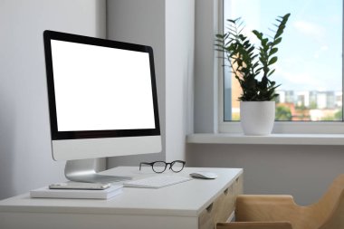 Workplace with modern computer and smartphone on white table. Mockup for design