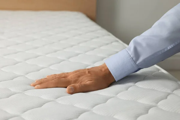 Man Touching Soft White Mattress Indoors Closeup — Stockfoto