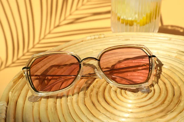 Stylish Sunglasses Wicker Mat Beige Background Closeup — Stock fotografie