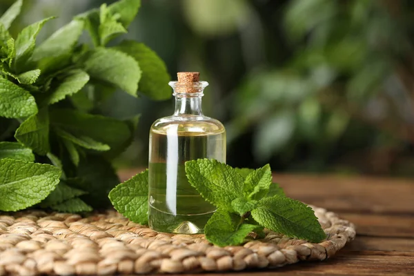 Bottle Mint Essential Oil Green Leaves Wooden Table Closeup — Fotografia de Stock