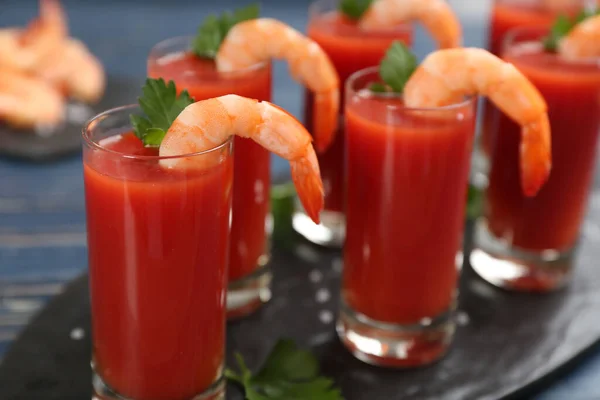 Shrimp cocktail with tomato sauce served on slate board
