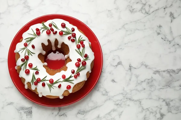 Traditional homemade Christmas cake on white marble table, top view. Space for text