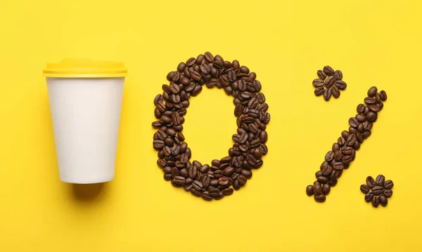 0 percent made of coffee beans and paper cup on yellow background, flat lay. Decaffeinated drink
