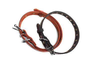Different leather dog collars on white background, top view