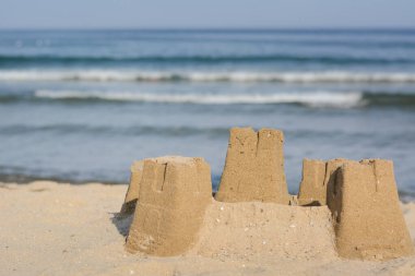 Beautiful sand castle on beach near sea. Space for text