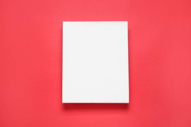 Blank canvas on red background, top view. Space for design