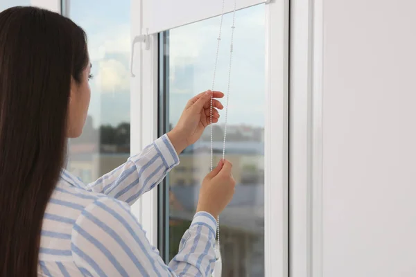 Woman Opening White Roller Blinds Window Indoors — Photo