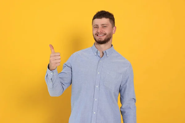 Young Man Showing Thumb Orange Background — Foto de Stock